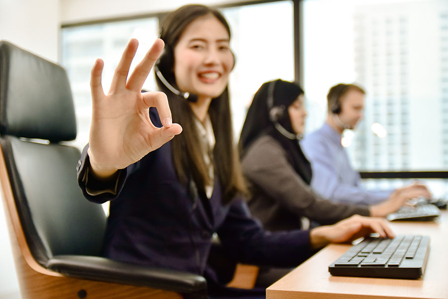 Smiling call agent signals okay